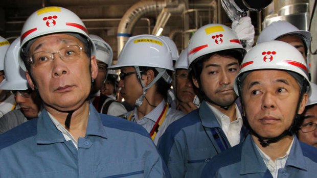 Grim news ... Tepco chairman Kazuhiko Shimokobe, left, and President Naomi Hirose   inspect the No. 4 reactor at Fukushima Dai-ni nuclear power station in Fukushima Prefecture on July 4, 2012.