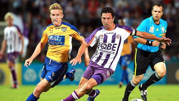 Ben Halloran of Gold Coast and Jacob Burns of the Glory contest the ball during the round 18 A-League match between the Perth Glory and Gold Coast United at nib Stadium on February 6, 2012 in Perth, Australia. <i>Photo by Paul Kane/Getty Images.</i>