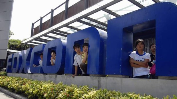 Workers at the gate of a Foxconn factory in the township of Longhua in Shenzhen, Guangdong province.