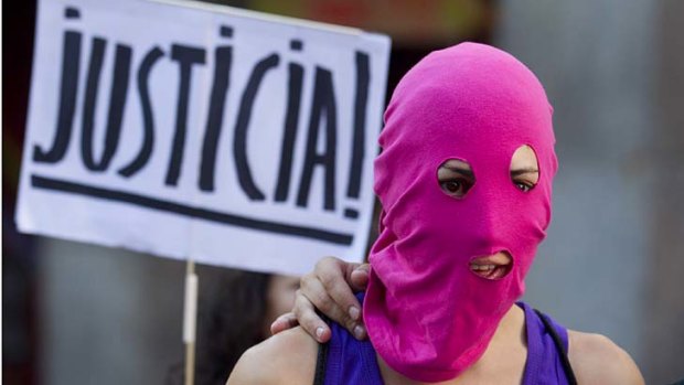 Brave face ... a Pussy Riot supporter in a balaclava outside Spain's Foreign Office in Madrid.