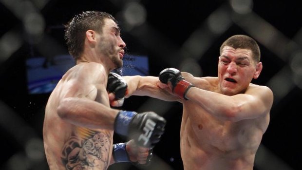 Nick Diaz, right, trades punches with Carlos Condit during their UFC interim welterweight mixed martial arts title bout.