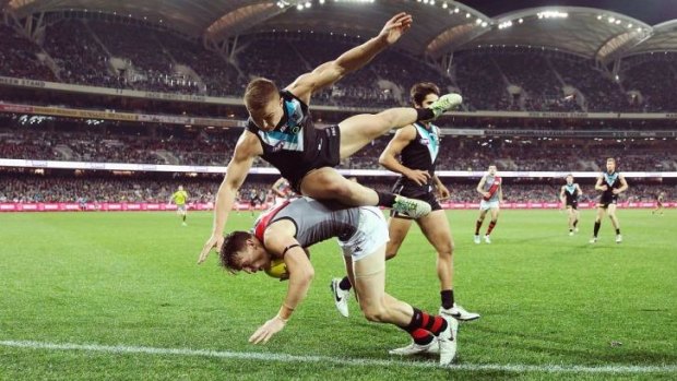Tangled affair: Port Adelaide's Ollie Wines competes with the Bombers.