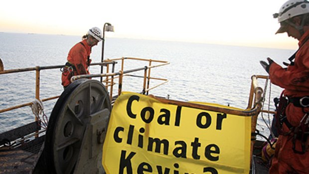 Greenpeace activists climb along the Hay Point Coal Terminal this morning.