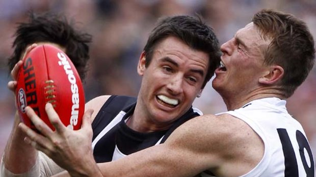 Saints midfielder Brendon Goddard gets up close and personal with Magpies ruckman Darren Jolly.
