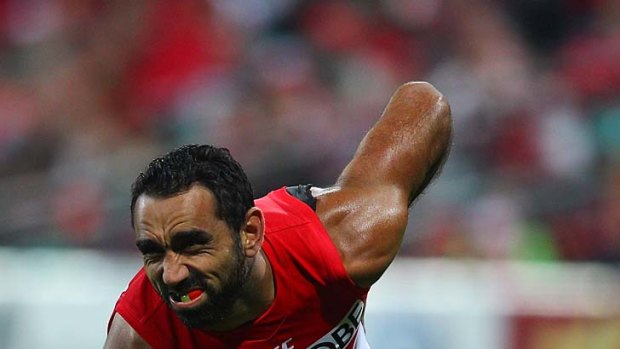 Adam Goodes grimaces as he holds his back during the match against the Adelaide Crows.