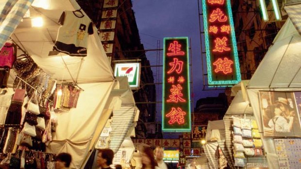 Locals exploring night markets in Hong Kong ... "Many Hong Kong people don't think they are Chinese," according to Kong Qingdong of Peking University.