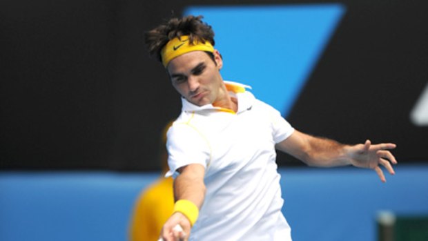 Roger Federer plays a powerful stroke on day one at Melbourne Park.