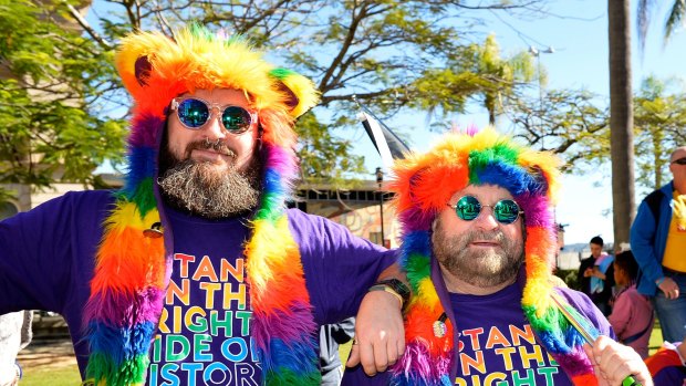 A gay couple show their colours at the marriage equality rally.