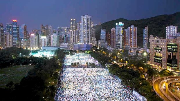 Thousands of people brave heavy rain to take part in a candlelight vigil in Hong Kong on the 24th anniversary of Beijing's Tiananmen Square protests.