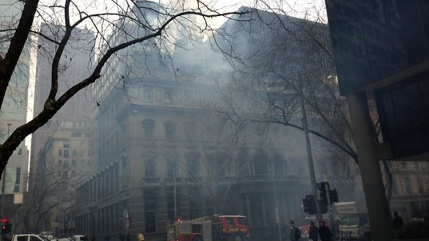 Smoke billows from The Australian Club, at the corner of William and Little Collins streets in the CBD.