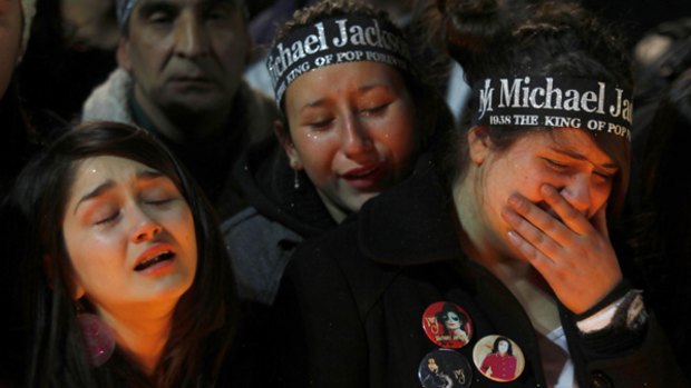 Distraught Michael Jackson fans gather at a vigil in Santiago.