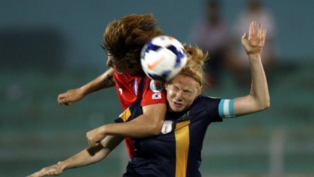 Tight tussle: Clare Polkinghorne of Australia clashes with Park Eun Sun of South Korea.