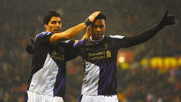 Daniel Sturridge (right) celebrates with Liverpool teammate Luis Suarez after scoring scores the team's fifth goal.