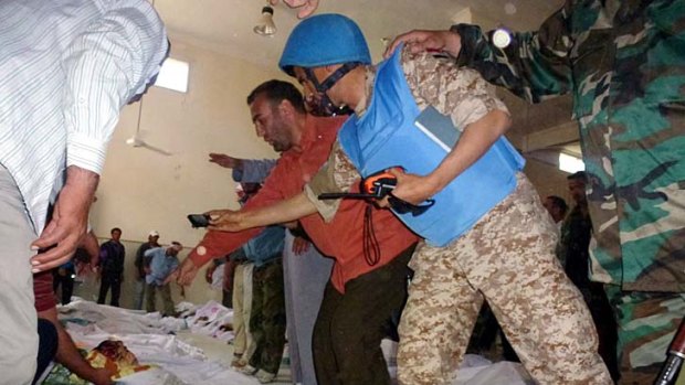 Horrific &#8230; UN observers take photos of the dead in Houla.