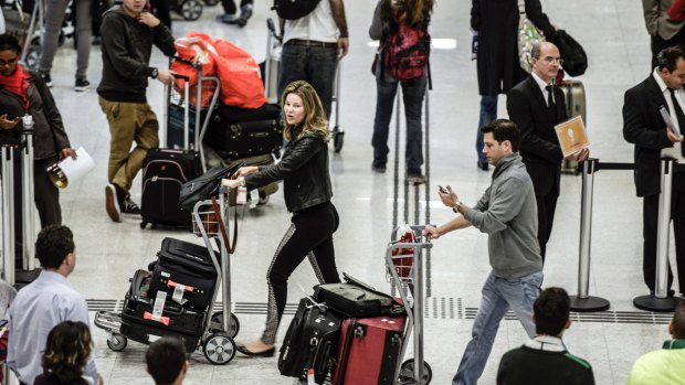 Passengers arriving from the US walk with their baggage through Terminal 3 of the Guarulhos International Airport in Brazil.