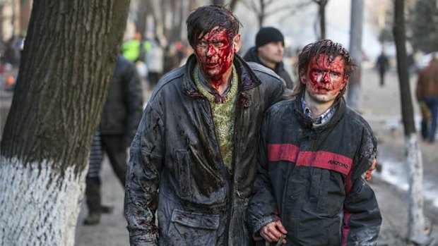 Wounded protesters leave clashes with police in Kiev.