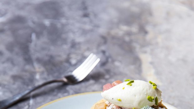 Pancakes with poached rhubarb, puffed grains, toasted hazelnuts and creme fraiche from St Ali in Yarra Place, South Melbourne.
