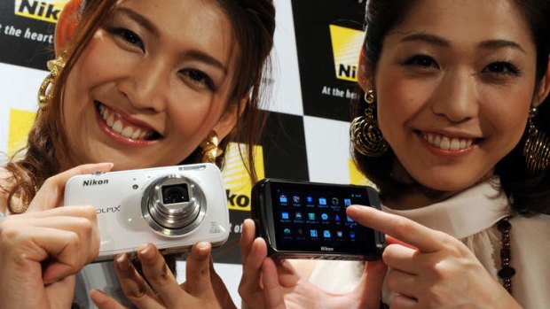 Models display the Nikon Coolpix S800c based on Google's Android OS in Tokyo.