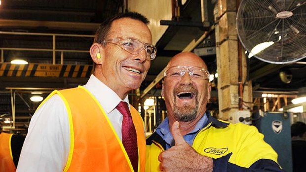 Tony Abbott is greeted by worker John Murphy at the Ford engine plant in Geelong.