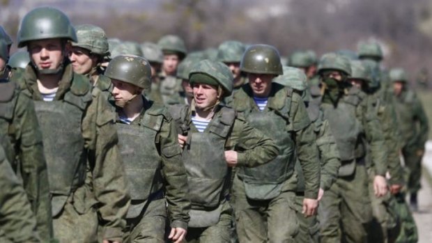 Uniformed men, believed to be Russian troops, march outside a military base in Perevalnoye, near the Crimean city of Simferopol.