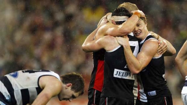 Saints captain Nick Riewoldt celebrates with vice-captain Lenny Hayes and tagger Clinton Jones after St Kilda held on to defeat Geelong. On the left is an exhausted Joel Selwood.