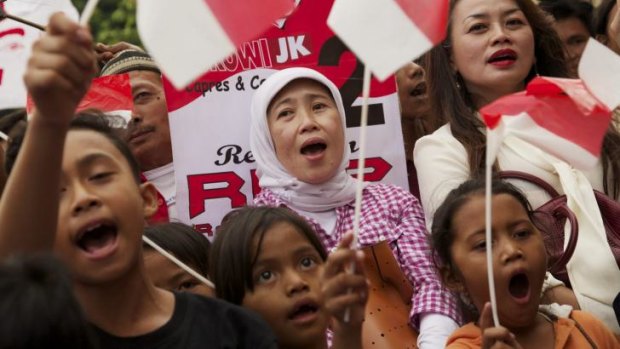 Supporters of Joko Widodo cheer at his election victory rally on Tuesday in Jakarta.