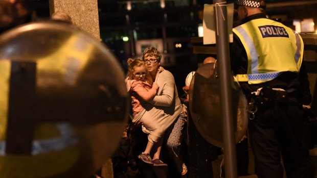 People are led to safety on Southwark Bridge away from London Bridge.