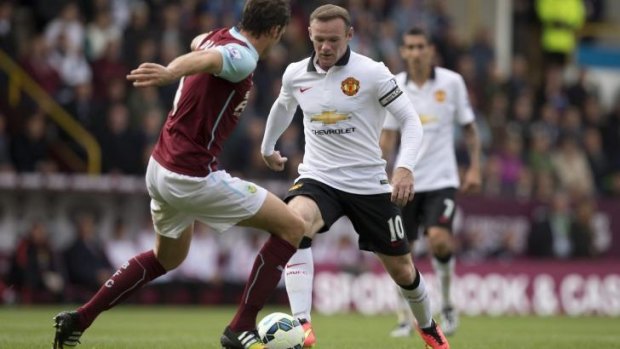 Manchester United's Wayne Rooney keeps the ball from Burnley's Michael Duff during the EPL match on Saturday.