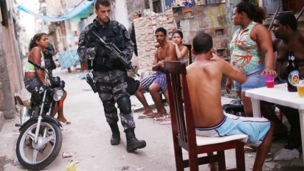  A Brazilian military police officer patrols the Mare slum complex.