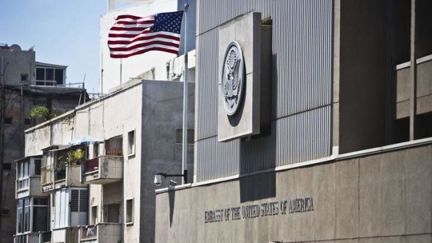 A flag flutters outside the US embassy in Tel Aviv after Washington and its allies issued travel warnings and closed embassies throughout the Middle East.