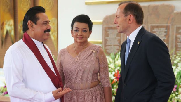 Tony Abbott, pictured with Sri Lanka's President Mahinda Rajapakse and his wife, has been criticised for giving Sri Lanka two boats to deal with people smuggling.