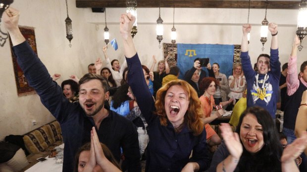 Ukrainians cheer while watching TV as Jamala wins the final of the Eurovision Song Contest.