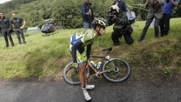 Spain's Alberto Contador holds his knee after crashing  on the 10th stage.