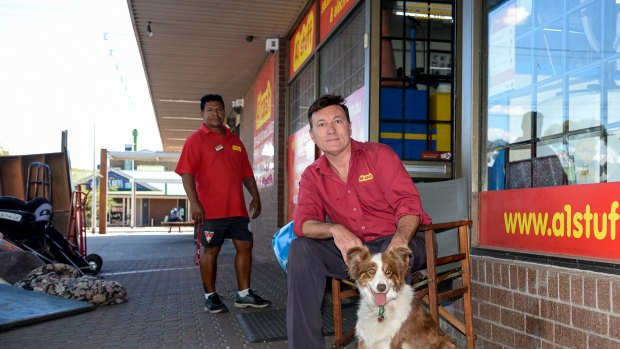 Gregory Heston with his dog Lucy outside his Melton second-hand furniture store.