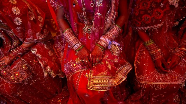 Indian brides from impoverished families wait for their grooms to arrive during a ceremony in New Delhi in February. An Indian bride has walked out of her wedding after her groom-to-be failed to add correctly, police said.