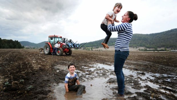 Muddy celebration: James and Tanya Scott with Ben, 5 and Harriet, 3, on their Mudgee farm.