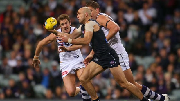 All class: Carlton's Chris Judd gathers the ball and prepares to charge away.