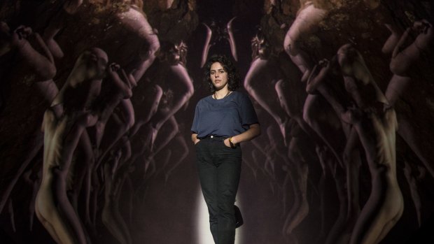 Artist Zoe Scoglio poses in the "cave of female flesh" she has created for the new Melbourne Opera production of Wagner's Tannhauser.