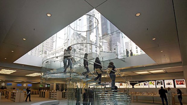 Heading to Canberra? Customers descend a glass staircase at the flagship Apple store on New York's Fifth Avenue.
