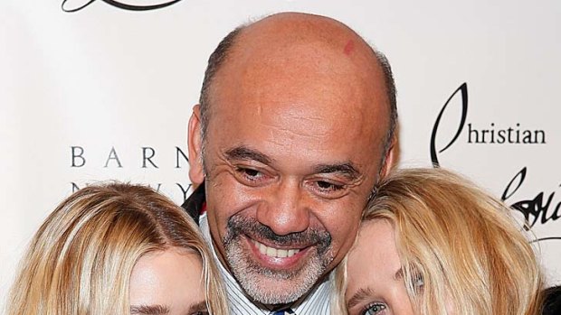 Christian Louboutin with Ashley and Mary-Kate Olsen at a party in New York to celebrate his 20 years in the fashion industry.