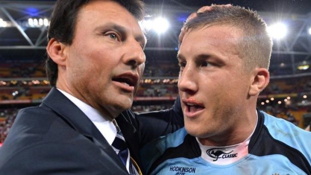 Blues coach Laurie Daley embraces Trent Hodkinson after NSW's upset victory over Queensland.
