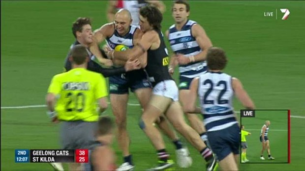 Geelong's James Podsiadly (centre) raises his elbow and and strikes St Kilda's Jack Steven (left) while being tackled.