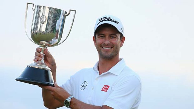 A long time coming: Adam Scott celebrates with the coveted trophy.