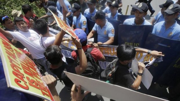 Police block environmental activists from getting closer to the US Embassy during a rally in Manila to coincide with the UN Climate Summit in New York.