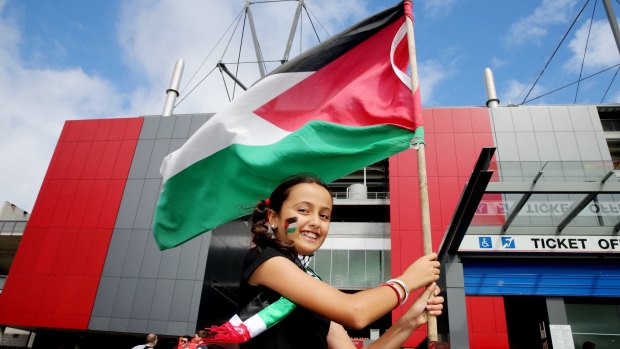 Nesreen Al-Mesqimi waves a Palestinian flag outside Hunter Stadium in Newcastle where Palestine played Japan in an Asian Football Confederation Cup match in January.