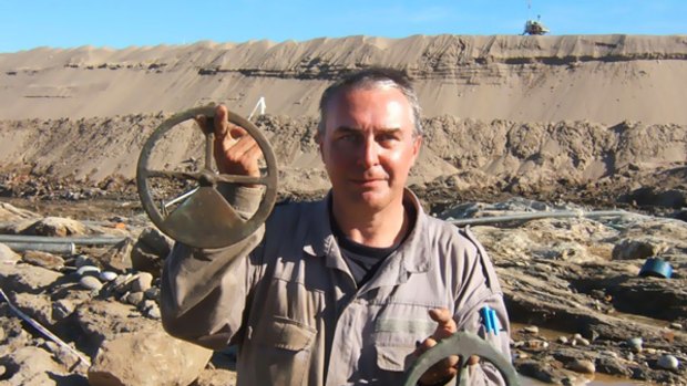 Archaeologist Bruno Werz holds astrolabes pulled from the seabed off Namibia where a Portuguese ship sank 500 years ago.