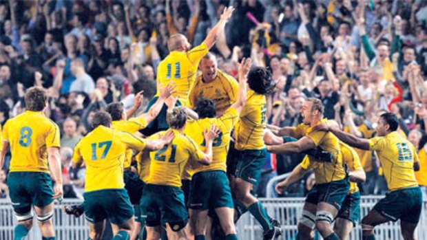 Jubilant Wallabies celebrate their drought-breaking win over the All Blacks in Hong Kong last night.