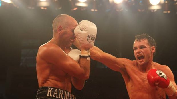 Judgment day ... Daniel Geale lands a right on Roman Karmazin at Homebush yesterday. Geale won by knockout in the 12th round.
