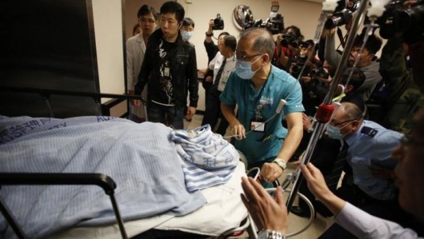 Critical condition ... former Ming Pao chief editor Kevin Lau Chun-to is wheeled into the operation theatre at a hospital in Hong Kong.