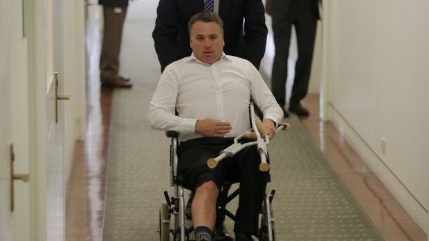 Jamie Briggs leaves the party room meeting in a wheelchair after the 2015 Liberal leadership spill. 